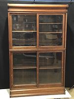 Full front view showing upper and lower glazed doors and overall proportions