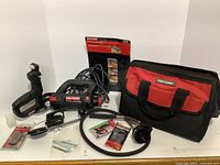 Full view of Craftsman cutting tool with flexible shaft, bag, bits, and accessories laid out
