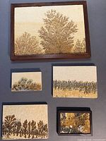 Top view of all 5 dendritic limestone slabs showing framed and unframed pieces with natural manganese oxide pattern.