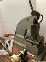 Bench-mount lever punch press and die set on wood table