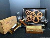 Full lot including antique hydrometer in wooden box, brandy warmer with snifter, wine box, wine bottle holder, crystal carafe and glasses, and bar tray.