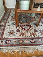 Overall view of rug under table showing full pattern and placement