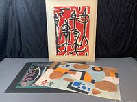 Group shot of all three unframed prints laid flat