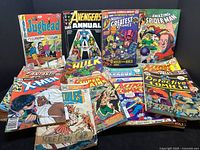 Overview photo showing various Marvel and DC comic books including Jughead, Avengers Annual, Fantastic Four, Spider-Man, X-Men, Hulk, Justice League, Action Comics, Detective Comics with visible age and wear.