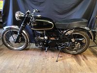 Right side profile of motorcycle showing frame, engine, exhaust and seating