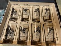 Set of 8 Federal Glass tumblers arranged inside original box, each tumbler features black bird illustrations including Canadian Goose, Canvasback, Grouse, Ring-Necked Pheasant.
