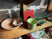 Various ceramic pieces including a scallop shell-shaped bowl, a long green planter with Greek key base, smaller matching candle holders, a green bucket-shaped container, a red-backed vintage novelty lamp, and a small candle lantern