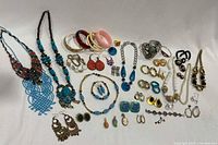 Full overview of the costume jewelry showing necklaces, bangles, bracelets, earrings, and rings in multiple colors and styles.