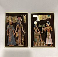 Both 3D plaques side by side showing the Egyptian pharaoh and goddess theme with multicolored enamel and metal 3D raised detailing.