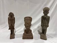 Front view showing Ramses II, Nefertiti bust, and Amun Ra statues, all sandstone color stone reproductions