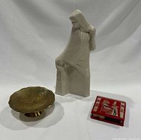 Overview photo showing all three items including the ivory white porcelain mother and daughter figurine, brass dish, and red Egyptian matchbox.