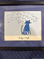 Front view of framed artwork featuring a blue cat with 'Purr' text and Andy Warhol signature.