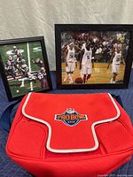 Photo showing two framed basketball photos and red NFL Pro Bowl 2010 cooler