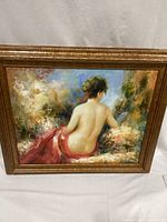Front view of framed oil painting showing nude figure from behind, red draped cloth, impressionist background and ornate gold frame.