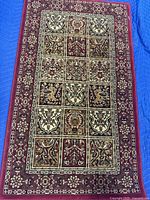 Full view of the Persian 100 Garden design red rectangular rug showing the whole pattern and border.