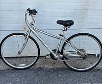 Side view of Raleigh Detour bicycle showing 17" silver aluminum frame, multi-speed gearing, 27" rear wheel, black seat and grips, and speedometer on handlebars.
