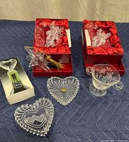 Wide shot of all items on blue surface showing angel ornament boxes, wine stopper, and two trinket dishes