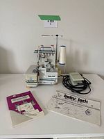 Front view of machine with foot pedal and manuals.