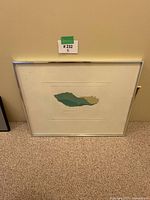 Full view of framed print against wall and carpet, showing overall condition and framing.