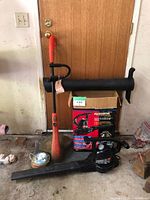 Photo showing the leaf blower, its basic shape and nozzle, alongside the orange Grass Hog edger with protective guard and power cords.