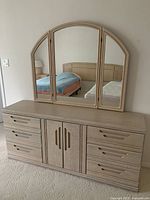 Frontal view of dresser with tri-fold mirror showing overall design and drawer layout