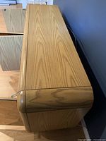 Top view showing wood grain and rounded edges of the cabinet.