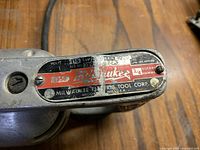 Close-up photo of the model and specification plate on the rotary hammer showing model 5350, 3/4 rotary hammer, voltage 115, 7.5 amps, 1000 RPM.