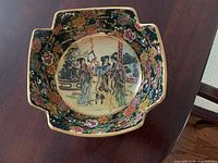 Top view of the bowl showing intricate oriental style painted scene with figures and floral designs.