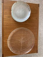 Top view of the glass salad server with embossed leaf pattern showing the frosted edges and textured surface.