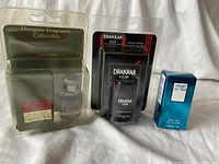 Photo showing the two unused cologne bottles in original packaging: a Hugo Boss 5ml bottle and a Drakkar Noir 15ml bottle