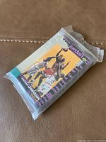 Sealed pack of basketball trading cards featuring Michael Jordan with image of him jumping and blocking two opponents on the front of the packaging.