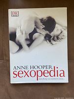 Front cover of the hardcover book titled 'Sexopedia' by Anne Hooper showing a black and white photo of a couple and the DK logo.