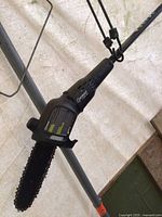 Full view of pole saw showing telescoping sections, foam grip and saw head