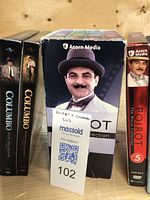 Five DVD box sets featuring Poirot and Columbo mystery collections, including sets 1-4 and 5 of Poirot movies and several Columbo DVD cases.