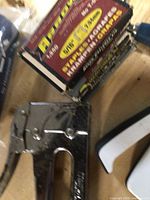 Arrow T50 manual staple gun with original box on a wooden surface