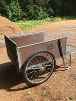 Overall right-side view showing plywood box, steel frame, wheels and handle