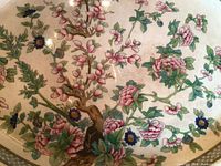 Close-up photo of 16-inch platter showing intricate floral design with pink flowers, green leaves, and golden accents.