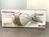 Brand new Think Kitchen food press in box and out of box in packaging