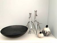 Overall view of the lot showing black decor bowl, chrome candle holders and ceramic vases
