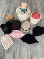 Nine various hats on floor including casual and dressy styles