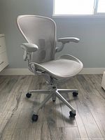 Front left angle view showing seat, arms, back and base