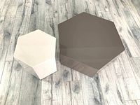 Both tables arranged on wood-look floor, showing relative sizes and hexagonal shapes.