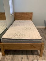 Front view of assembled bed frame with mattress