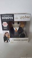 Front view of the Handmade by Robots Harry Potter Hermione Granger vinyl figure in its original box, showing figure number 063 and series Knit Series.