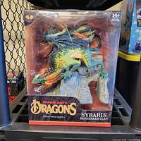 Front view of the boxed McFarlane Toys Dragons Series 8 Sybaris Berserker Clan figure showing detailed dragon and packaging graphics.