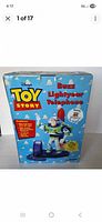 Photo of the front of the original box showing Toy Story Buzz Lightyear Telephone branding and images.