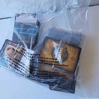 Plastic bag containing multiple stacks of World of Warcraft trading cards, card backs visible with logo and artwork.