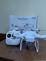 Drone assembled with battery and remote controller in front of original box