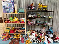 Wide photo showing entire toy lot on shelving and floor.
