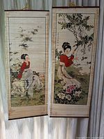 Front view of two bamboo hanging wall scrolls featuring Asian ladies in nature scenes